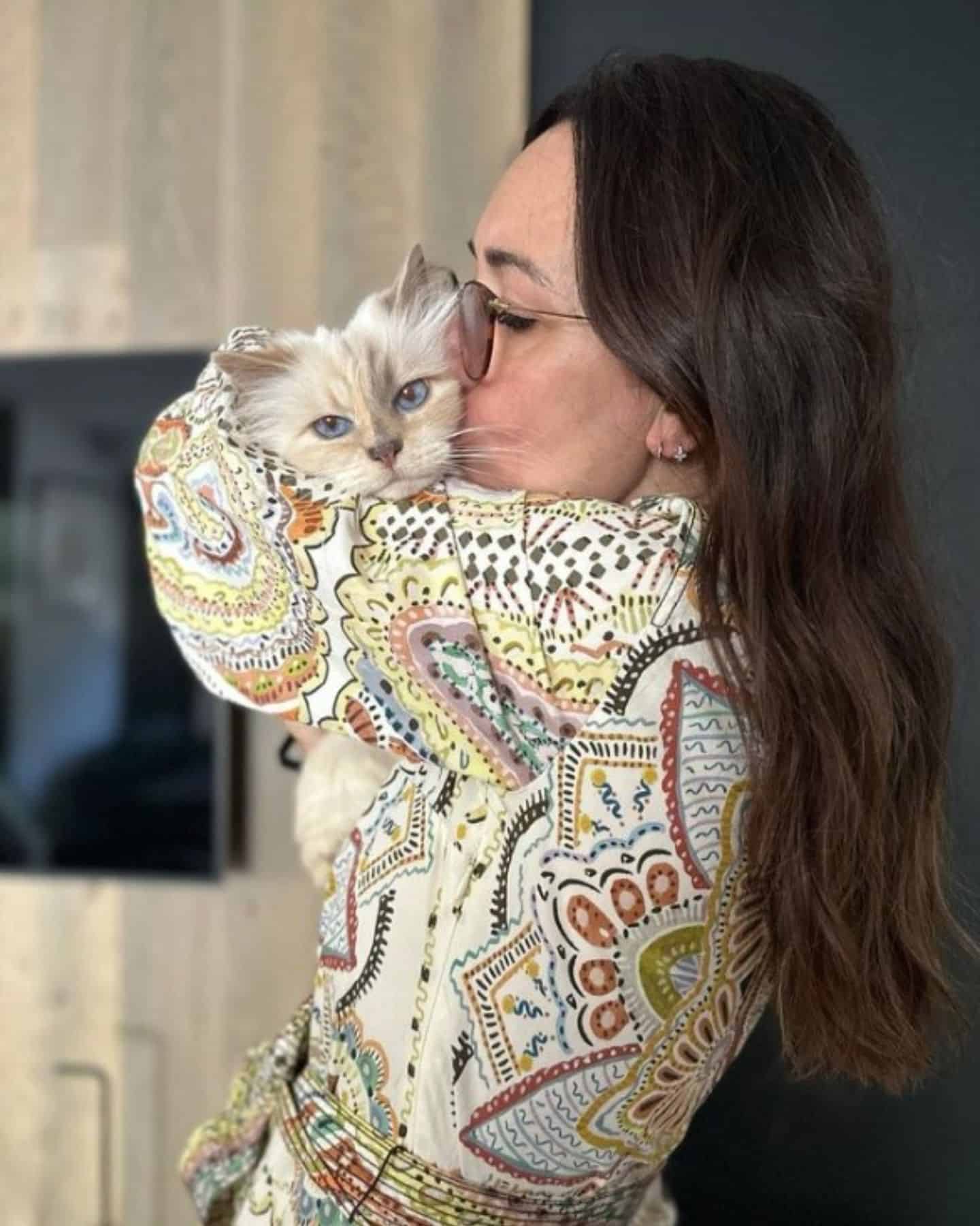 woman kissing a cat