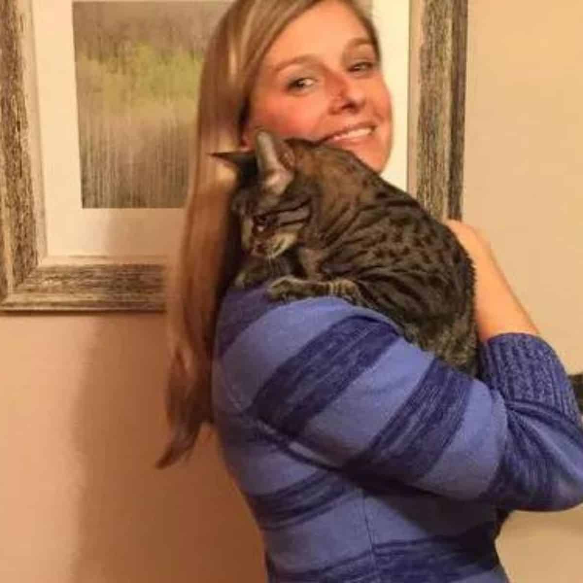 Woman holding cat in her arms