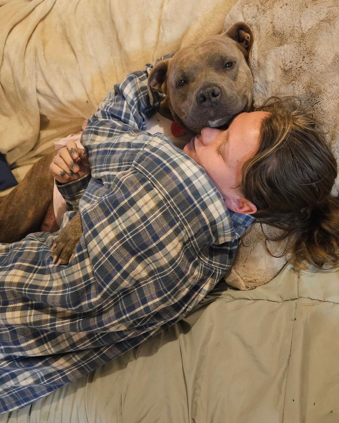 Woman sleeping with mother dog