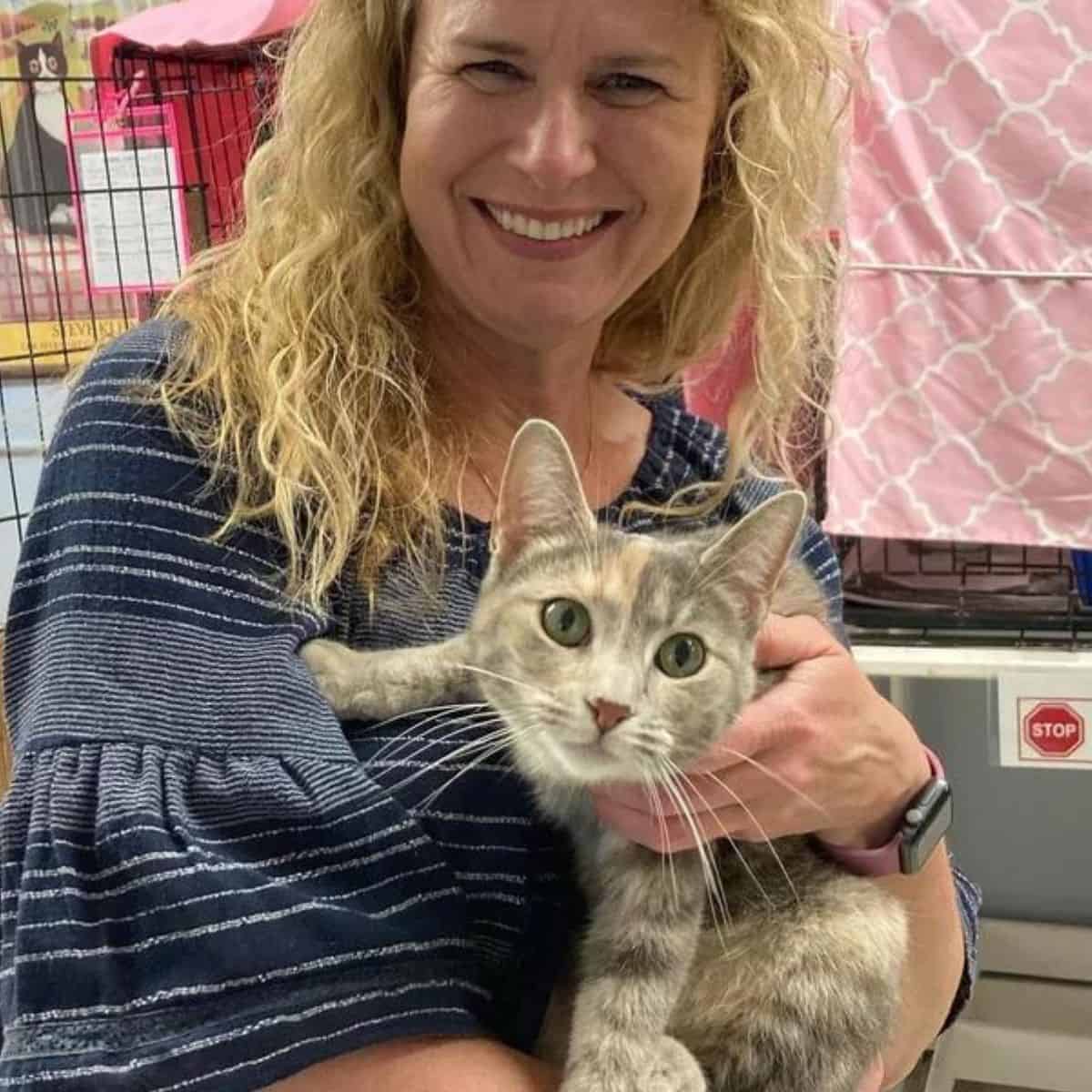 blonde woman and grey cat