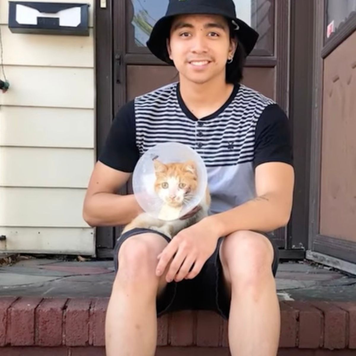 guy with earring holding cat