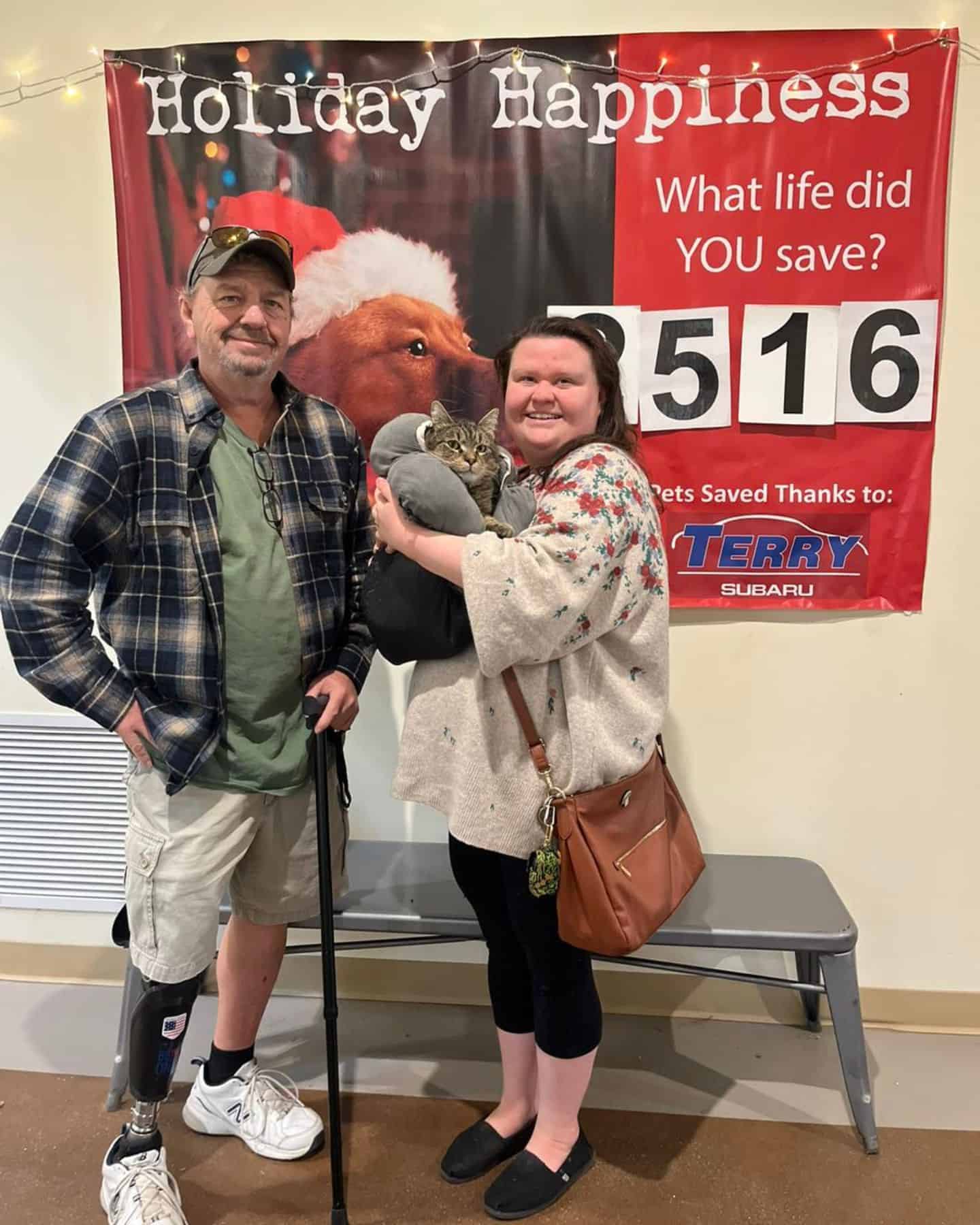 guy with prosthetic leg and woman holding a cat