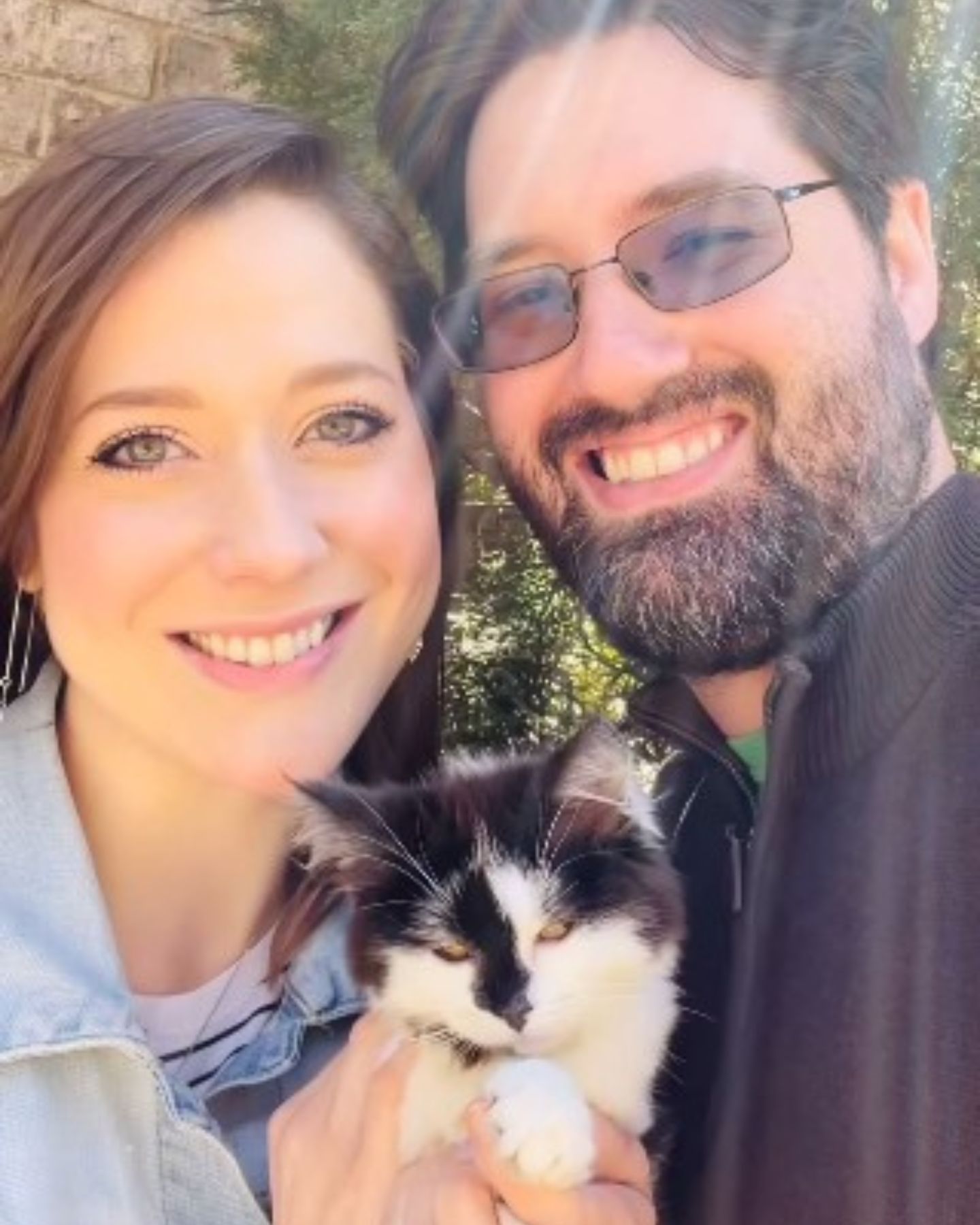 happy couple and kitten