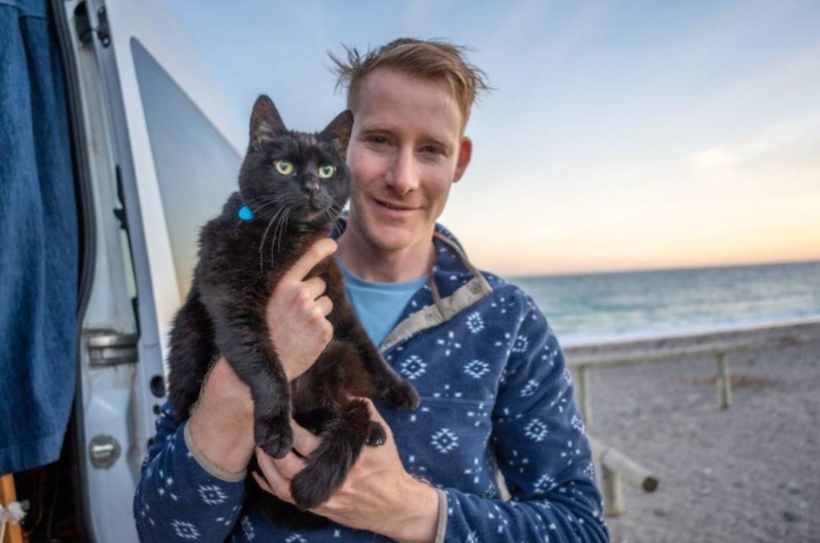 man holding a cat in his arms