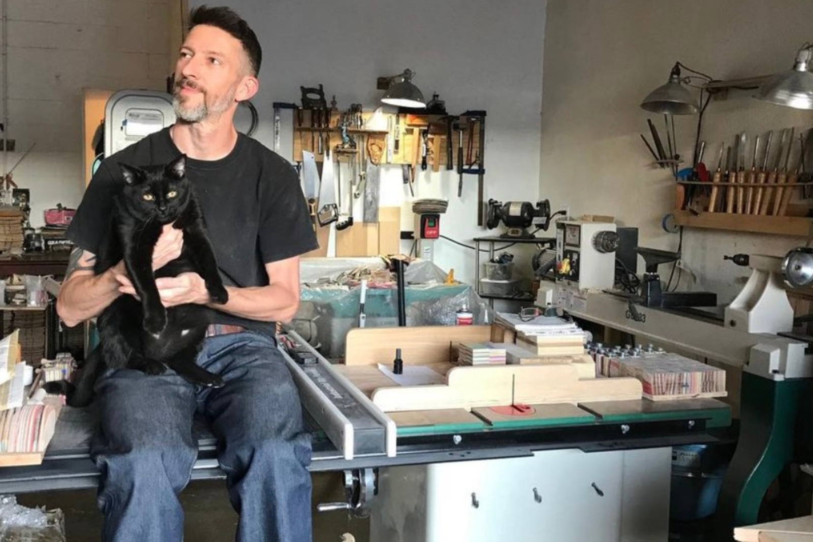 man holding a cat in shop