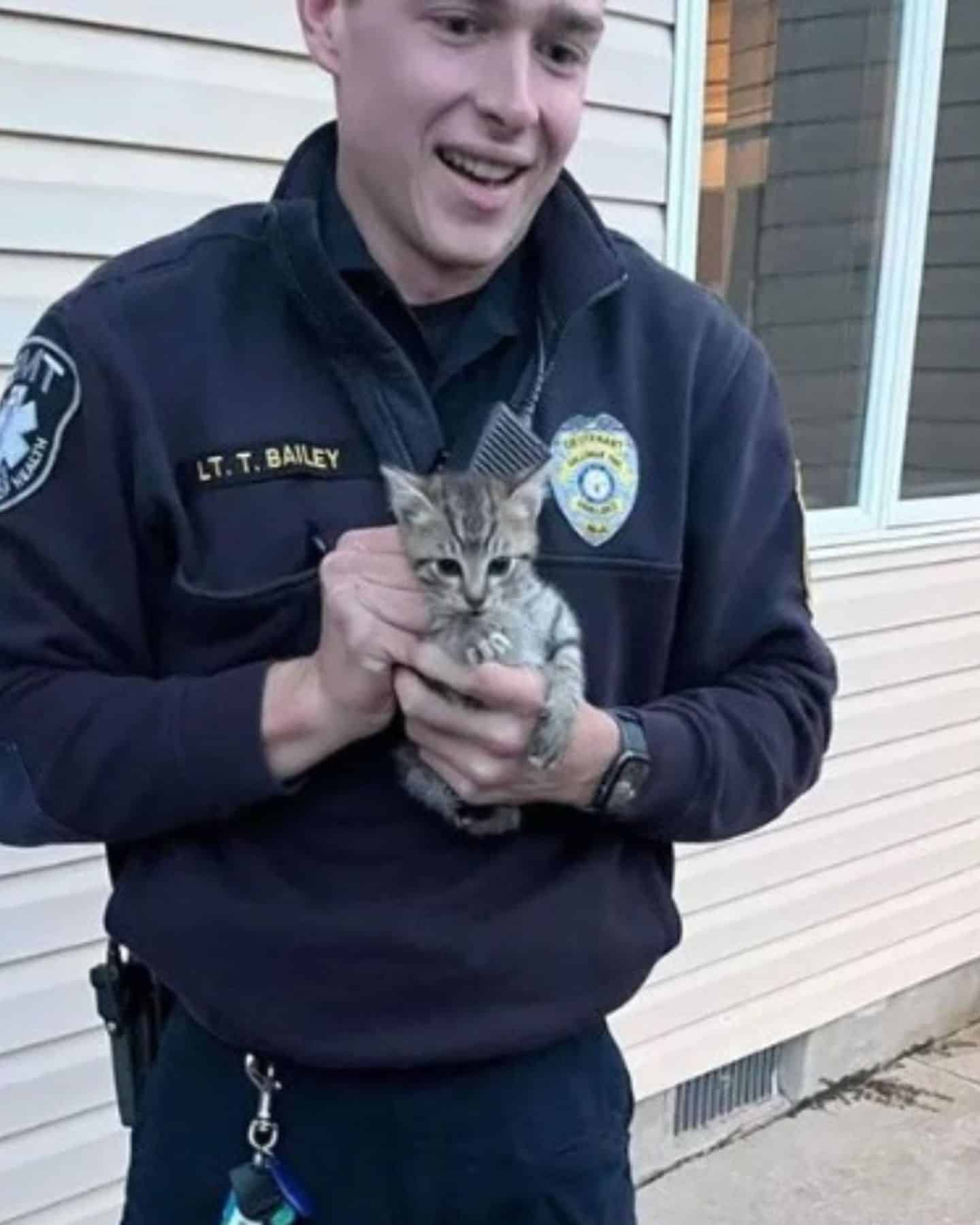 policeman holding a kitten