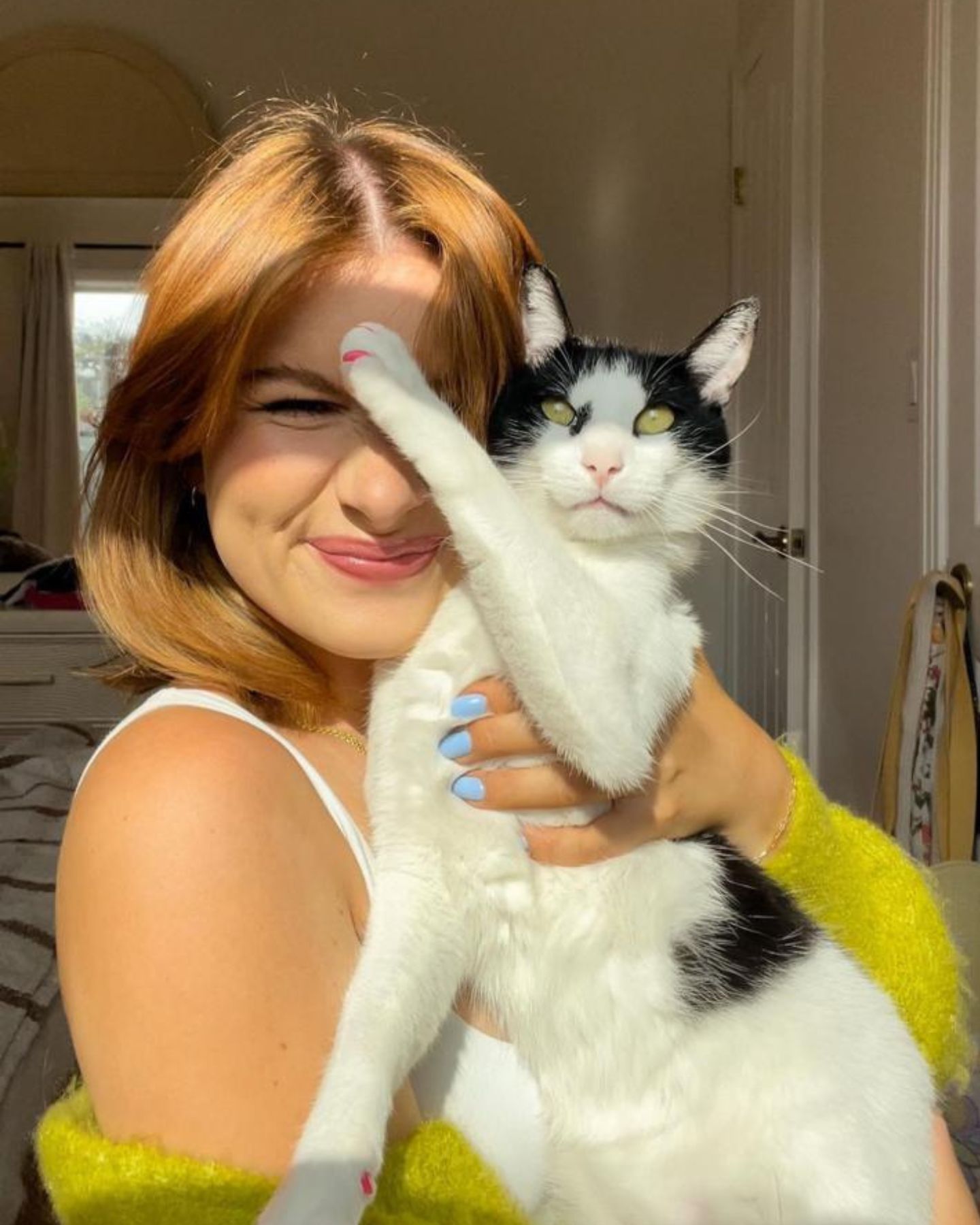 smiling woman holding kitten