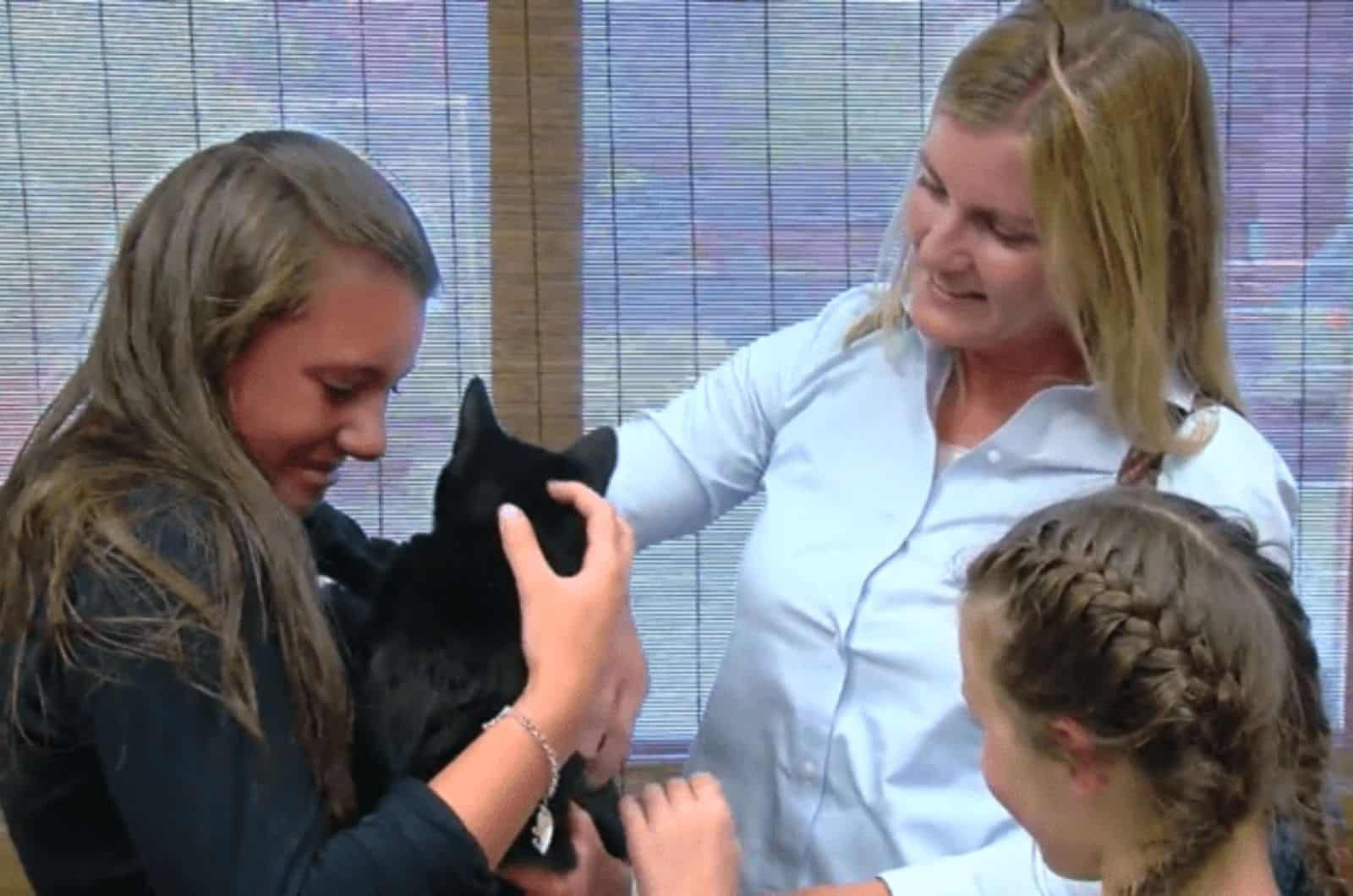 three women and black cat