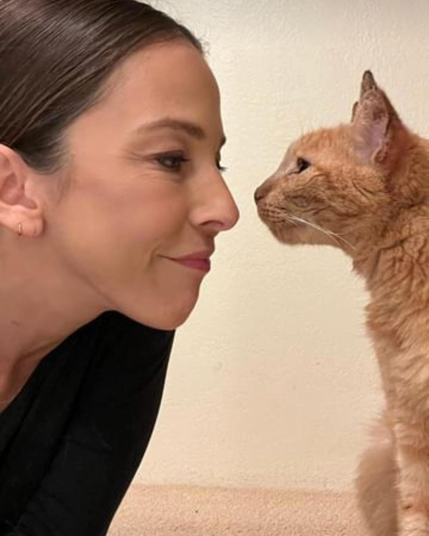 woman and cat watching each other in the eyes