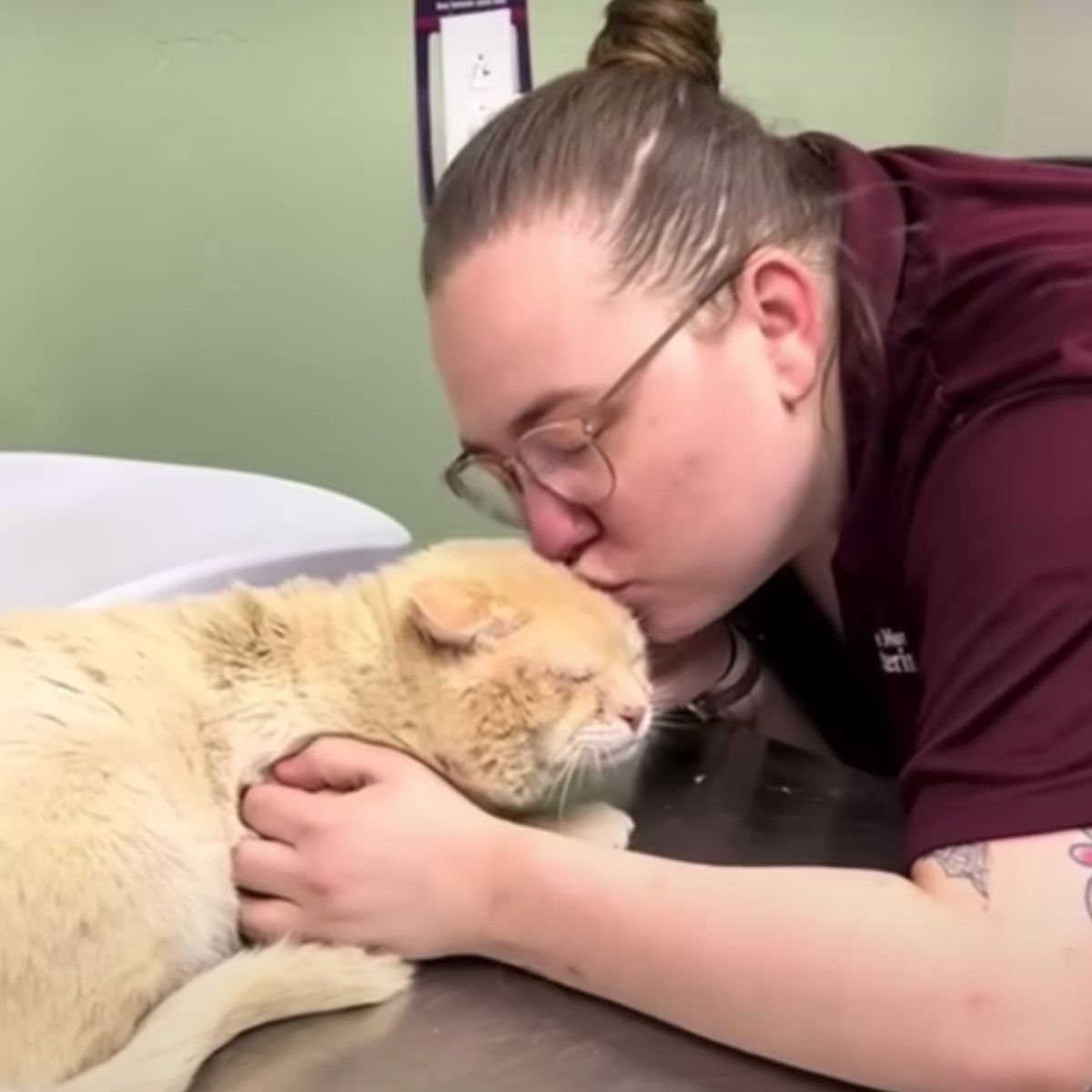 woman giving cat a kiss