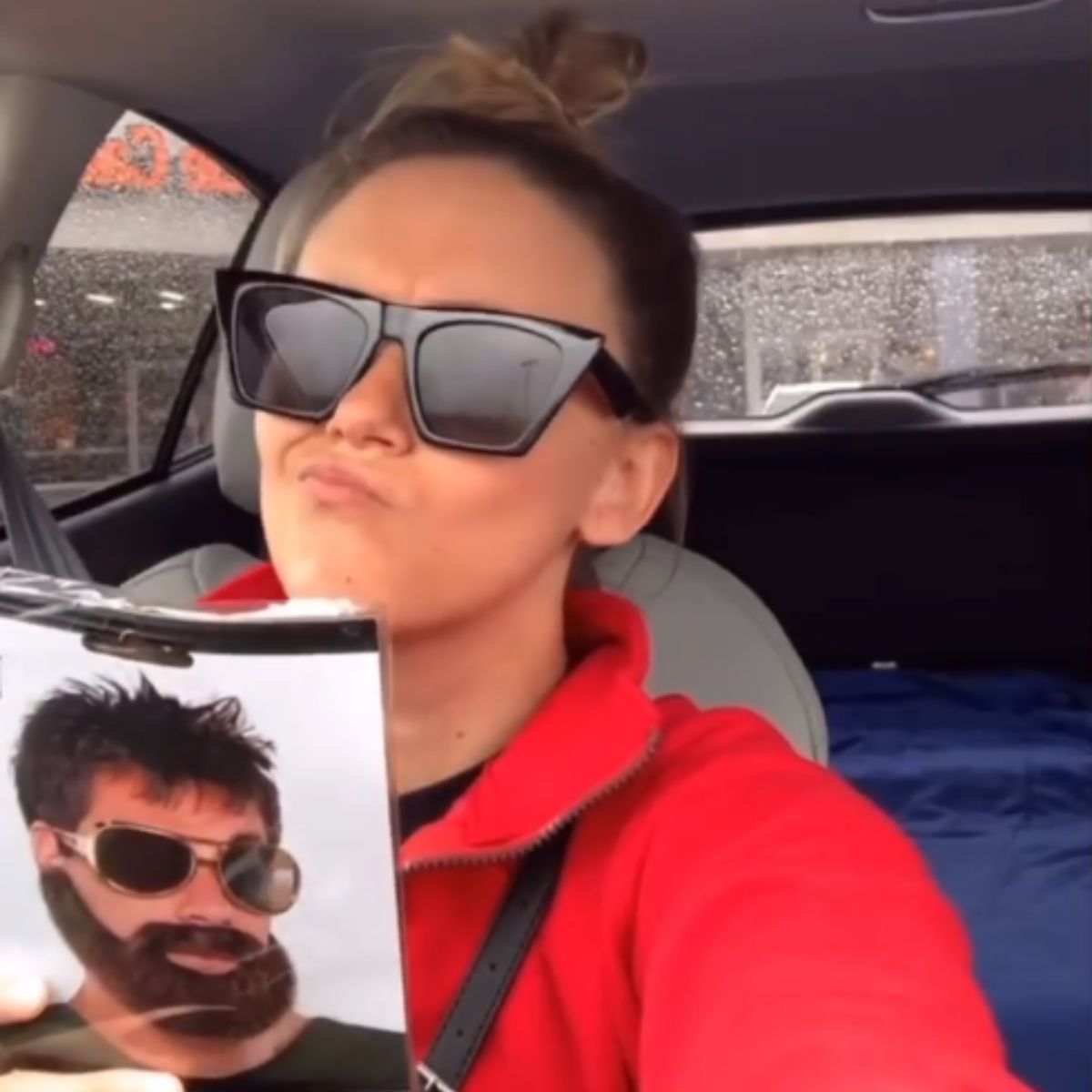 woman holding a photo of husband