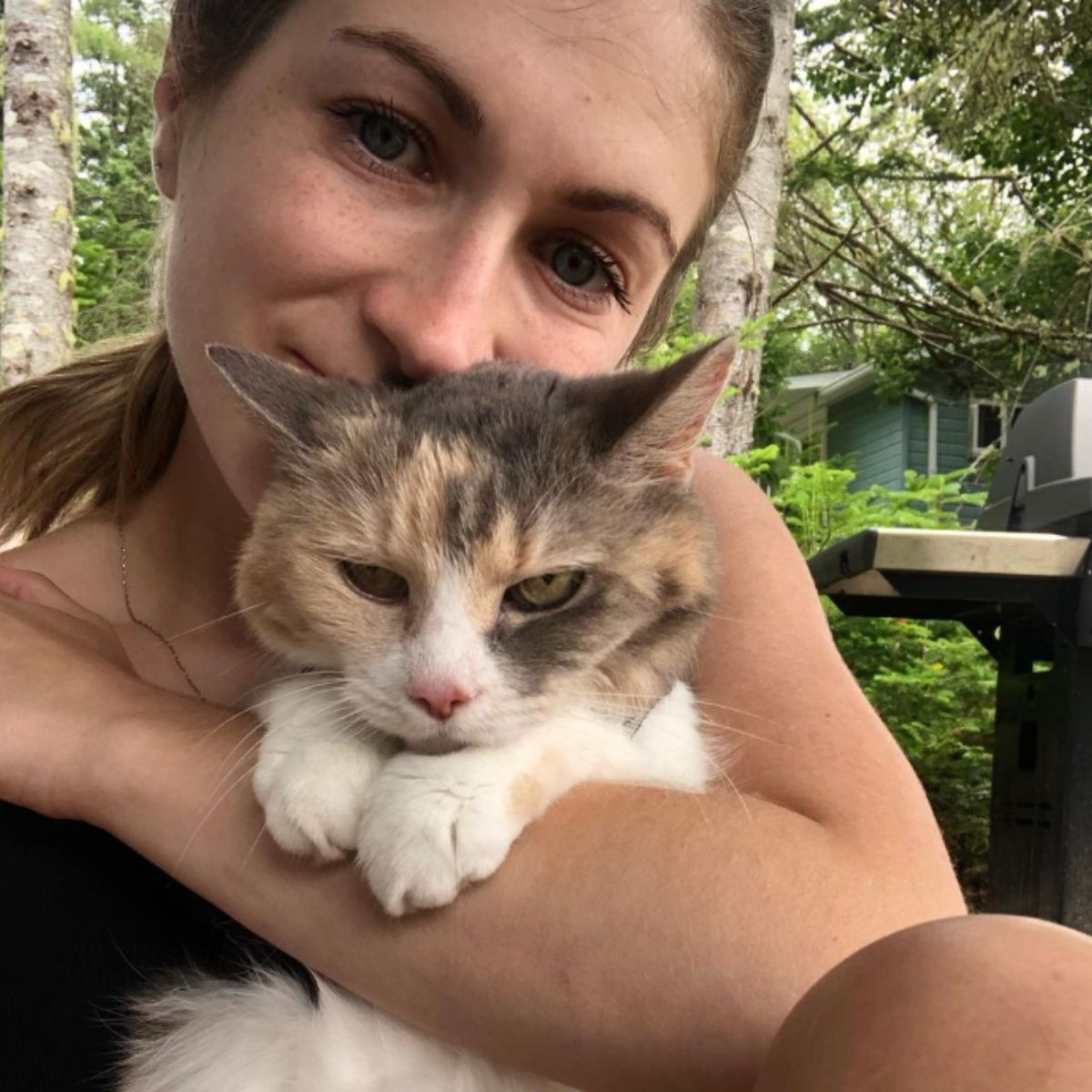 woman holding an old cat