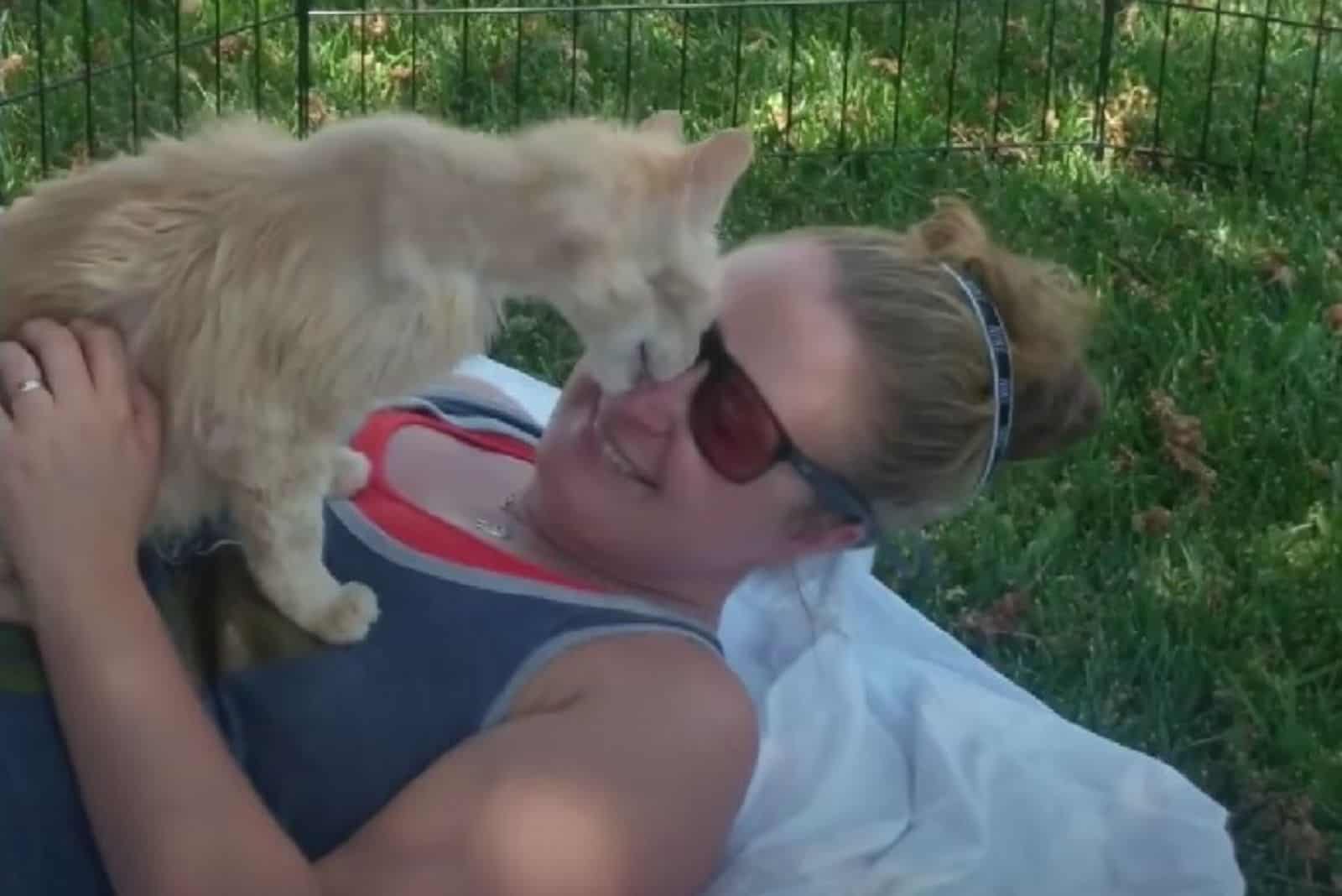 woman playing with cat