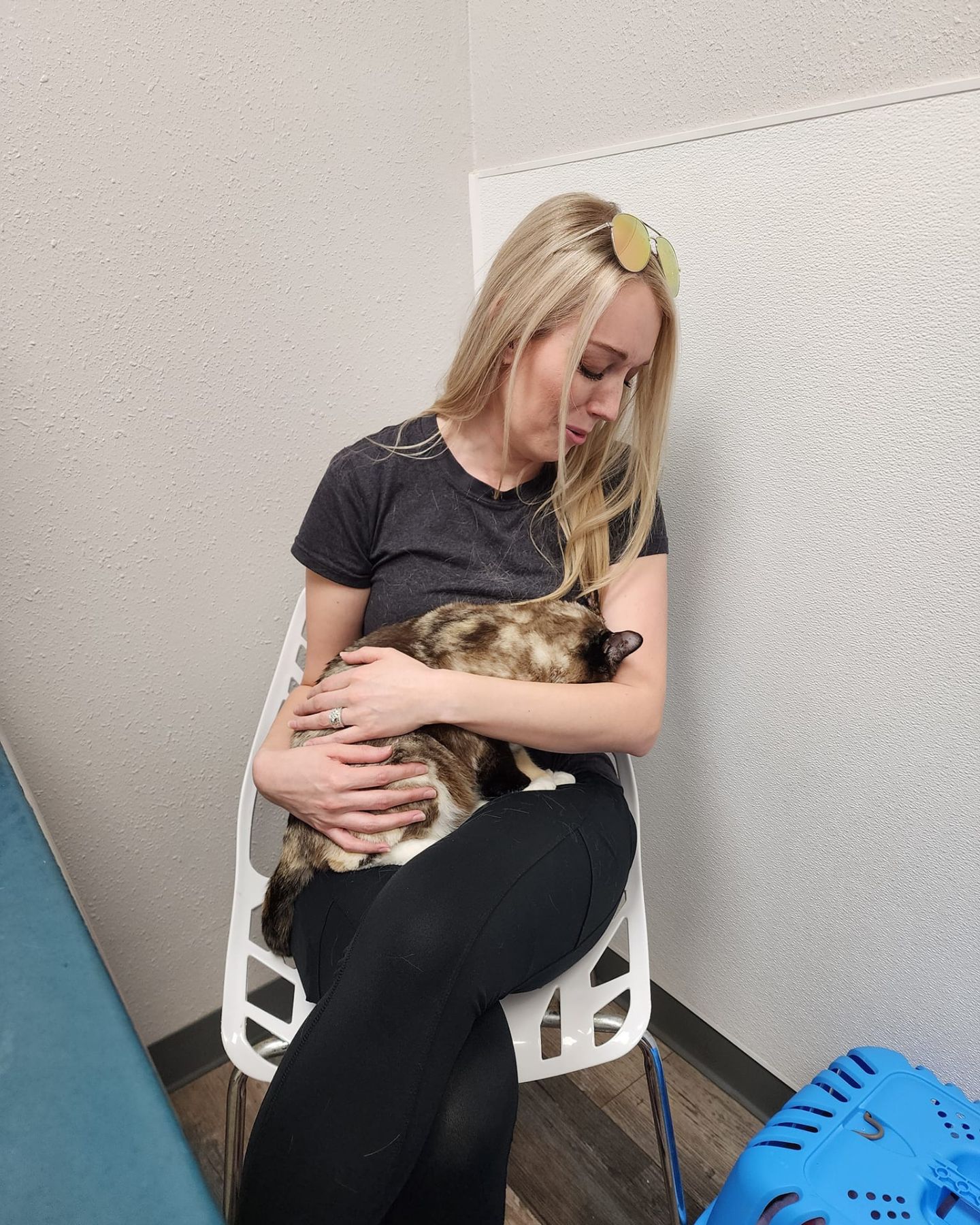 woman sitting and holding a cat