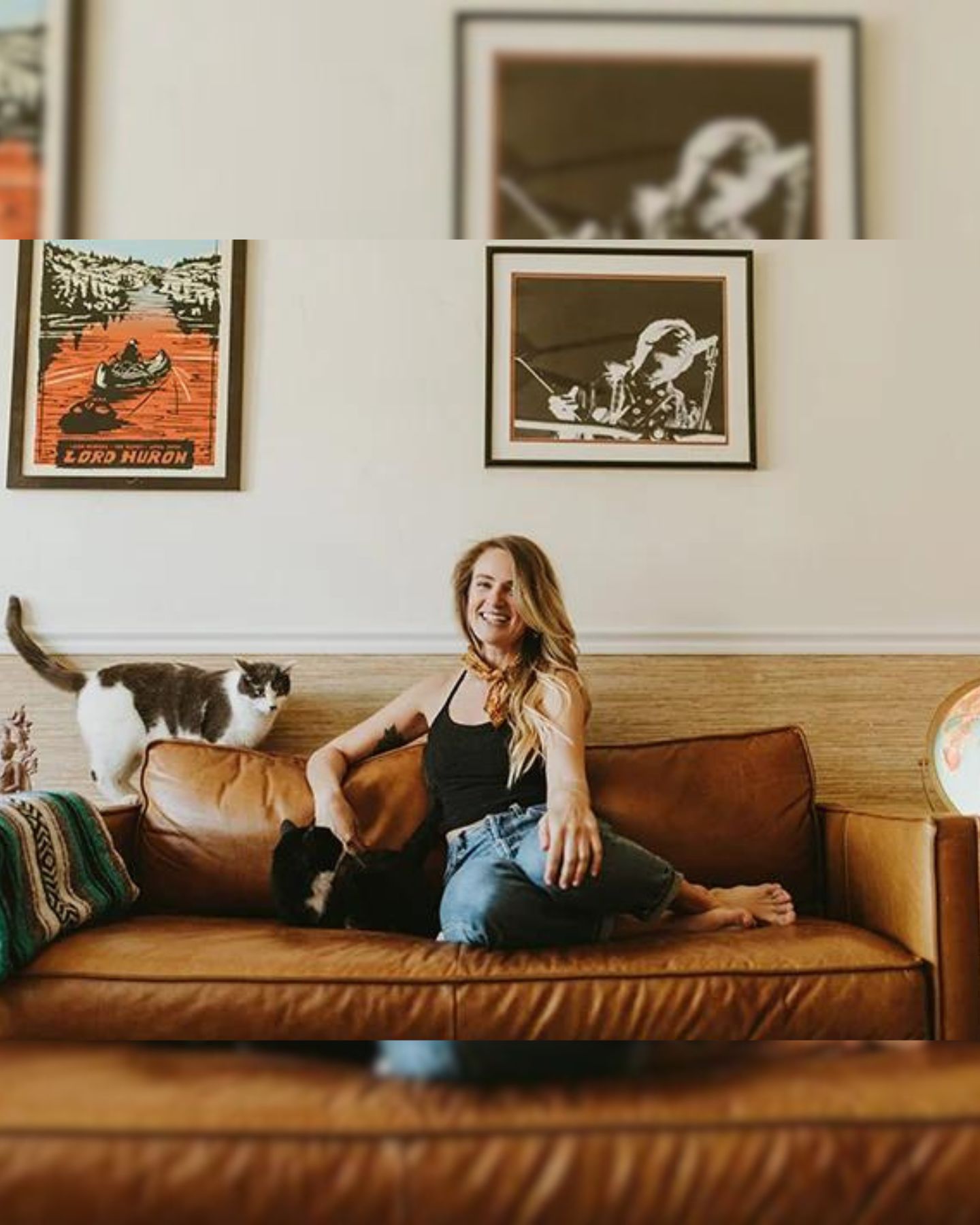 woman with two cats on a couch