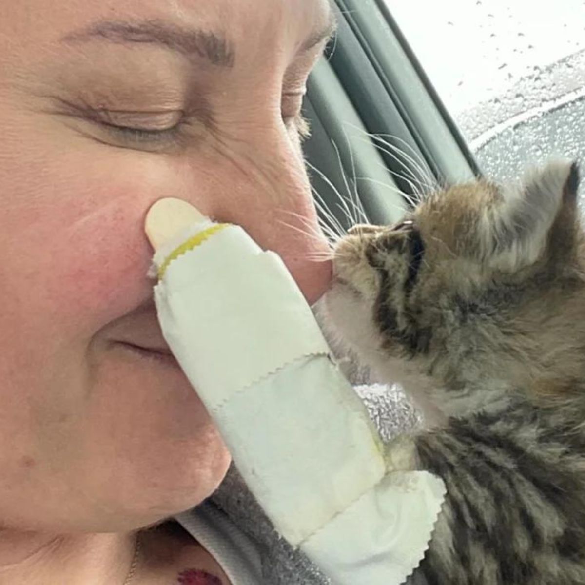 woman and kitten cuddling