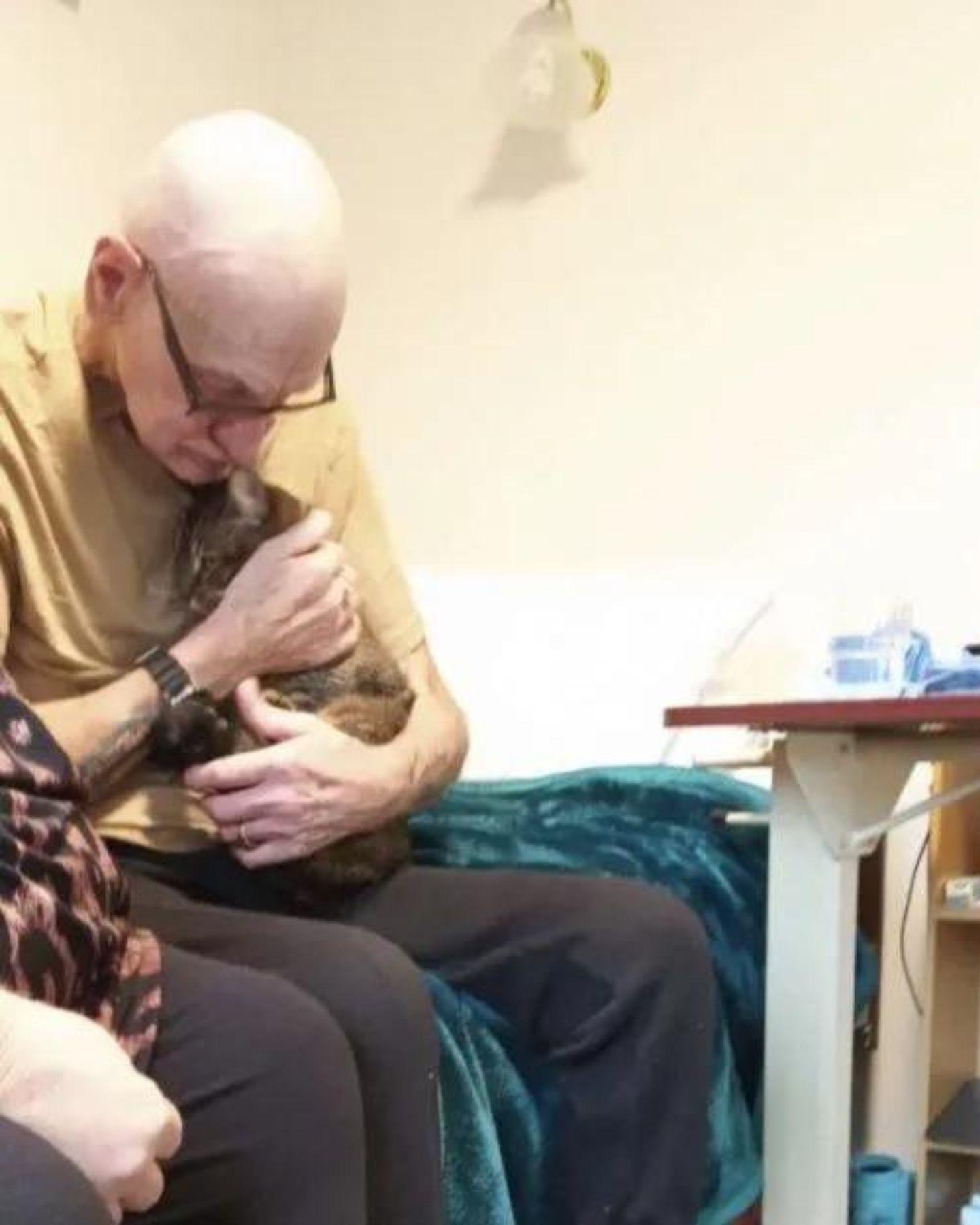 grandpa holding cat in arms