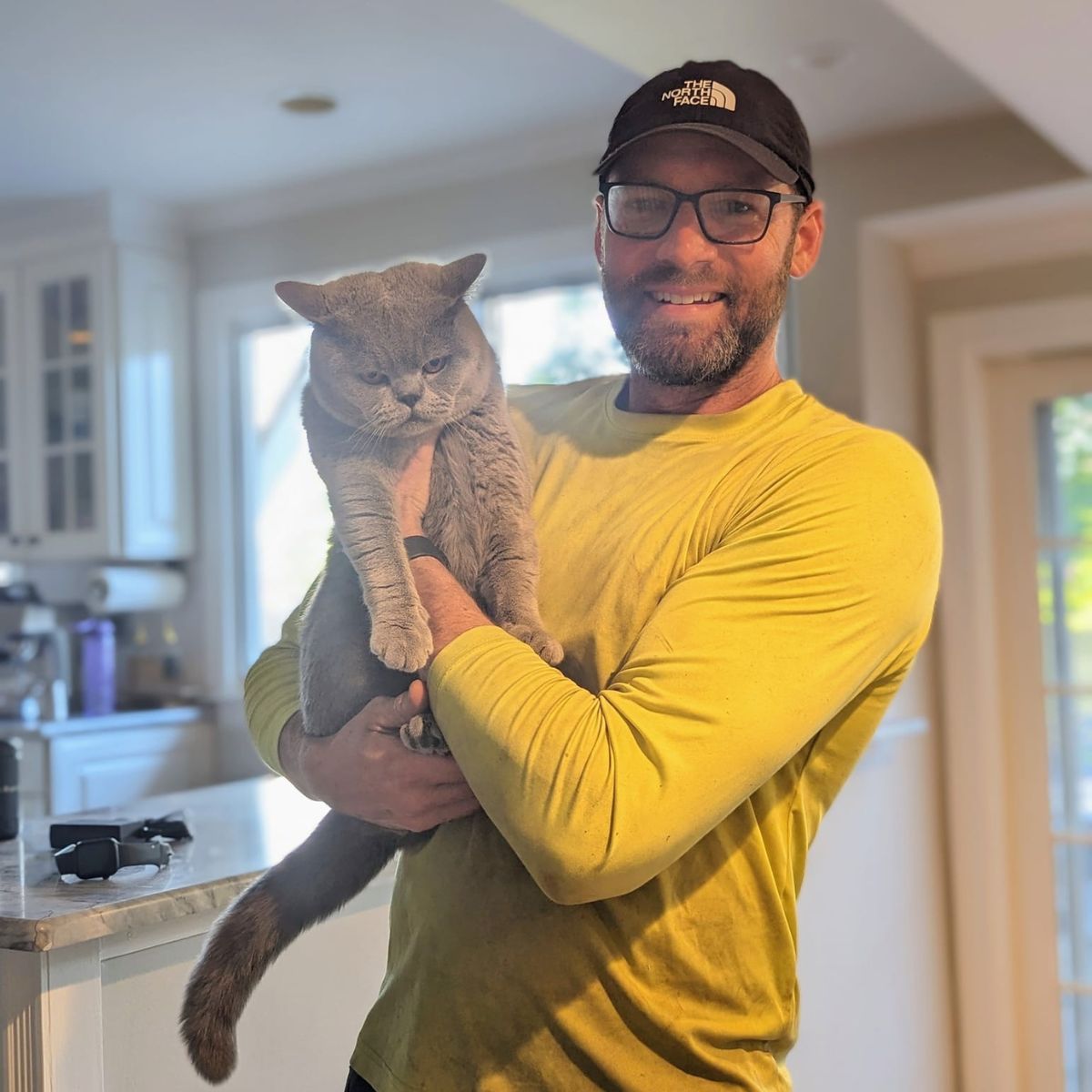 man holding rescued cat